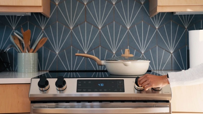 Hand adjusting Smart Knob in kitchen