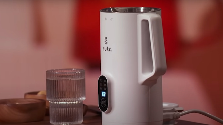 nutr machine next to glass of water