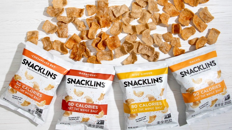 Snacklins bags scattered across table