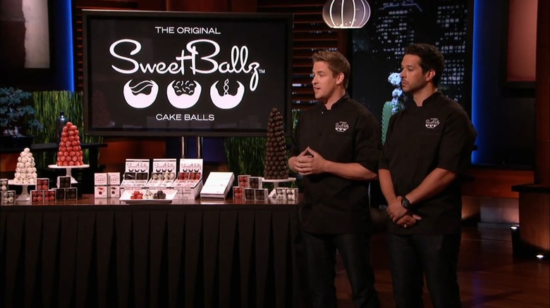 Partners James McDonald (left) and Cole Egger (right) standing next to table display of Cake Ballz, presenting their idea to Shark Tank investors