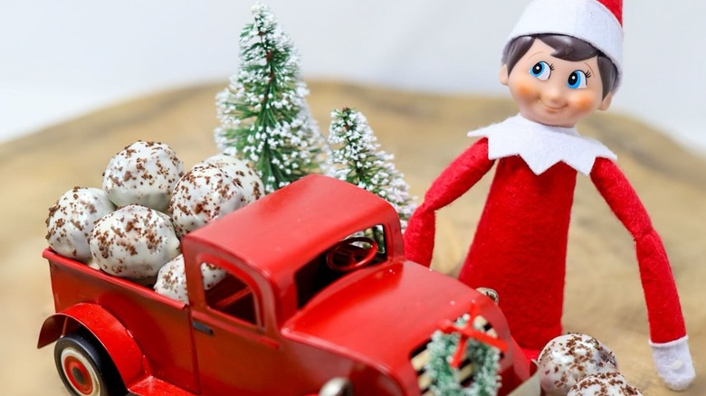 Cookies and cream Sweet Ballz in the bed of a red toy truck with Christmas decorations and elf
