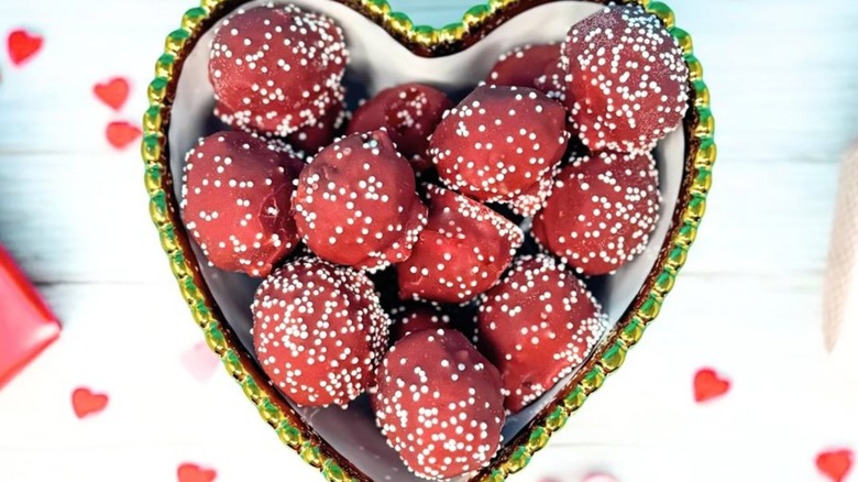 Heart-shaped bowl filled with red velvet Cake Ballz for the Valentine's holiday