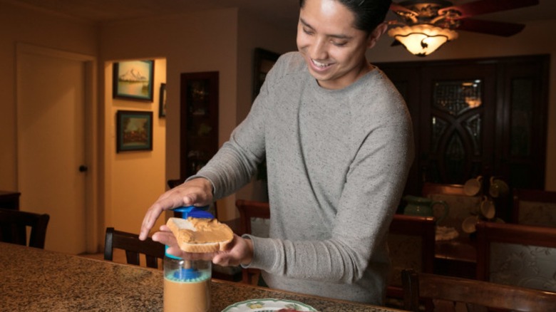 man using peanut butter pump