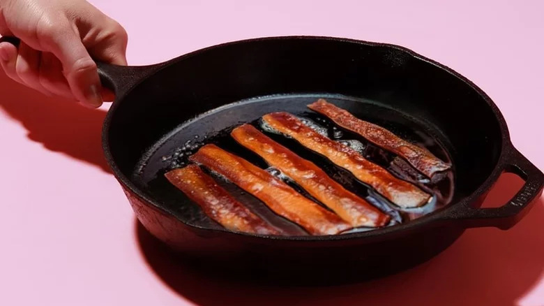 Umaro seaweed bacon cooking in a cast-iron skillet