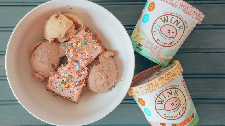 A bowl of Wink Frozen Desserts next to two pints