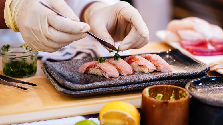 Omakase chef with sushi plate