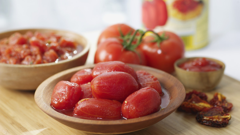 Peeled tomatoes in a wood bowl