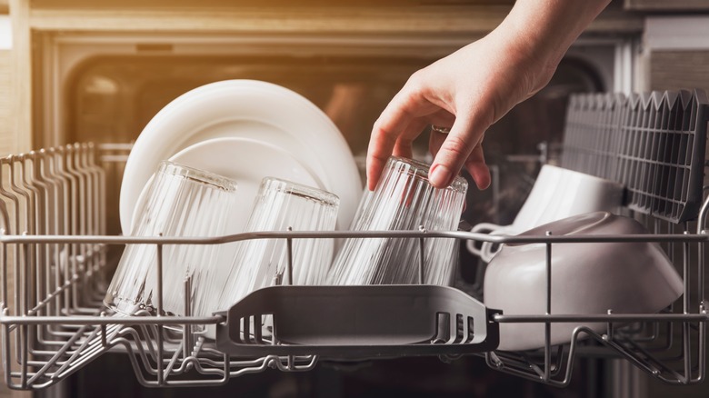 unloading dishes from dishwasher