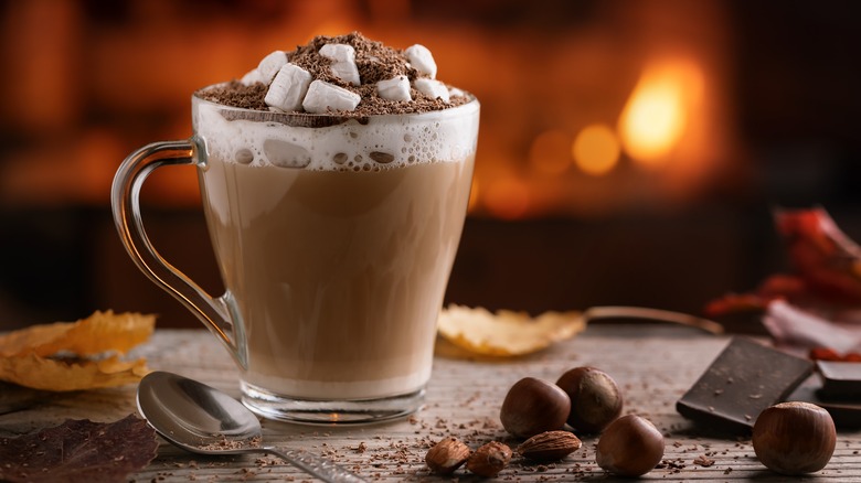 A cup of hot chocolate with marshmallows and chocolate shavings