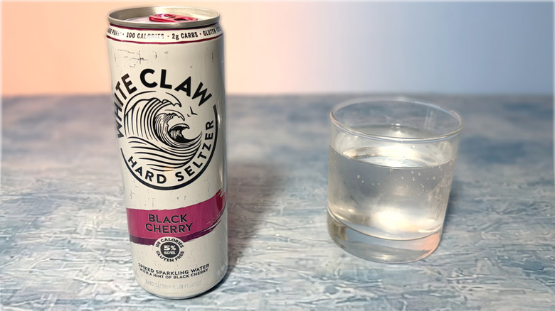can and glass of white claw hard seltzer