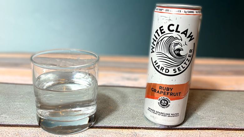can and glass of white claw hard seltzer
