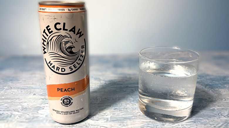can and glass of white claw hard seltzer