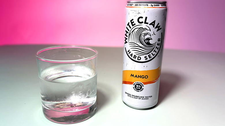 can and glass of white claw hard seltzer