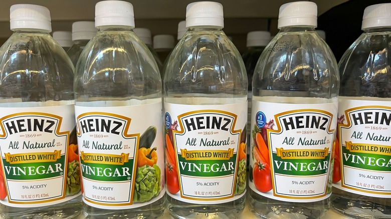 Rows of Heinz distilled white vinegar on a store shelf