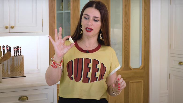 Pasta Queen with lemon between fingers white kitchen