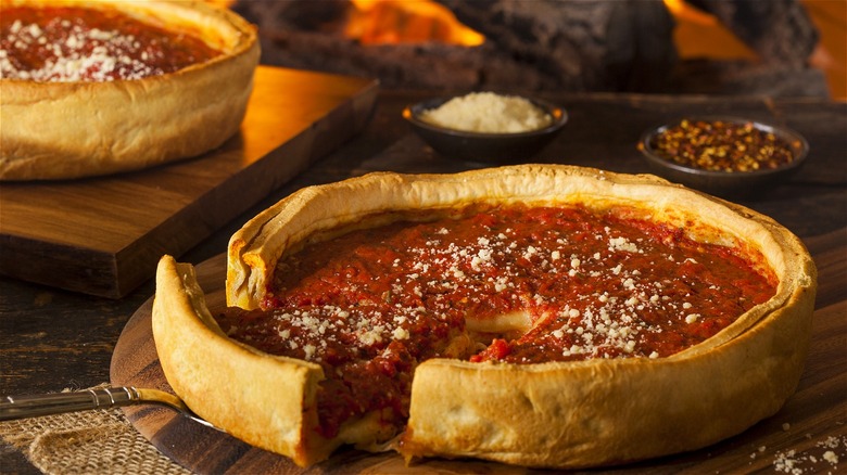 Deep-dish pizzas on wooden boards