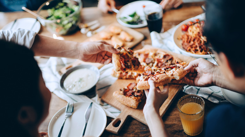 Friends sharing pizza and salad