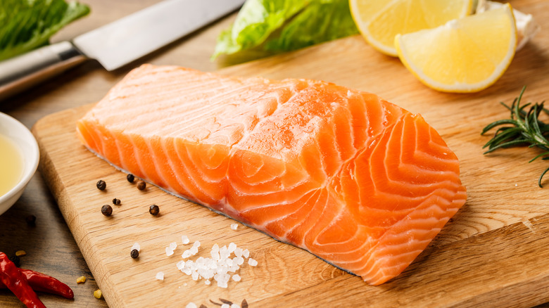 salmon on cutting board with seasonings