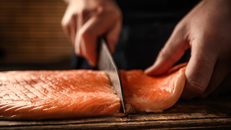 knife cutting salmon filet