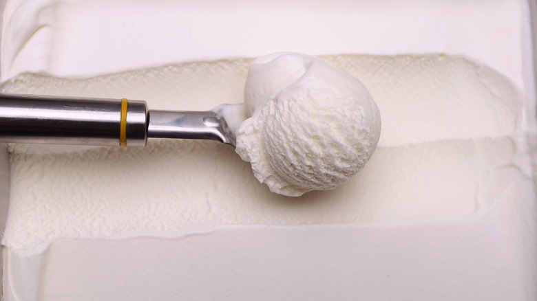 Silver scoop in vanilla ice cream