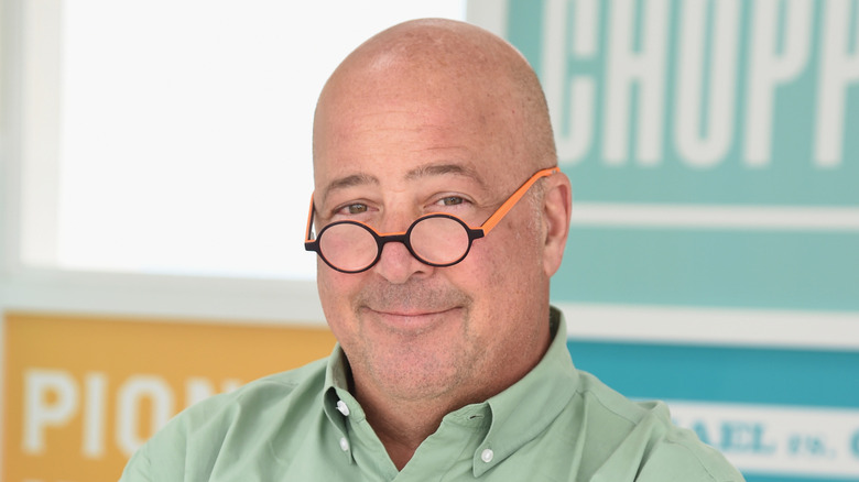 andrew zimmern in glasses, smiling