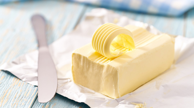 unwrapped butter stick and knife