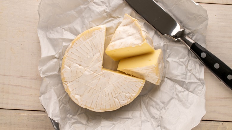 Brie cheese wheel and slice