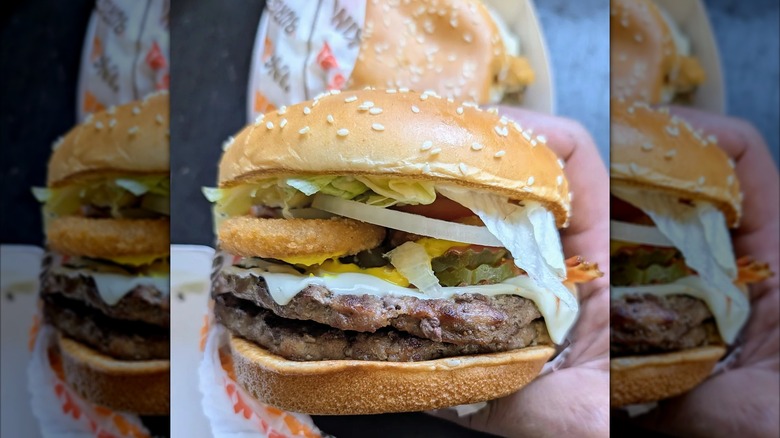 A hand holding a Whopper