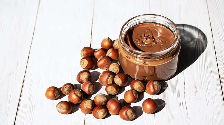 jar of chocolate hazelnut spread with hazelnuts