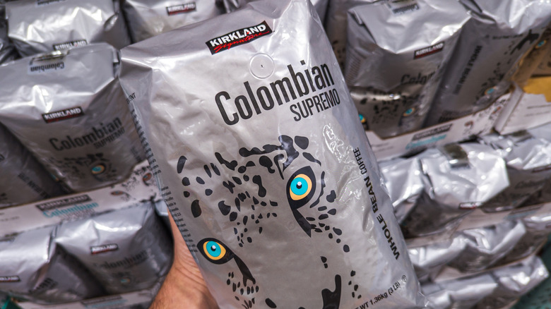 person holding a bag og Kirkland coffee