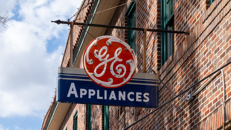 GE Appliances neon sign hanging from brick building