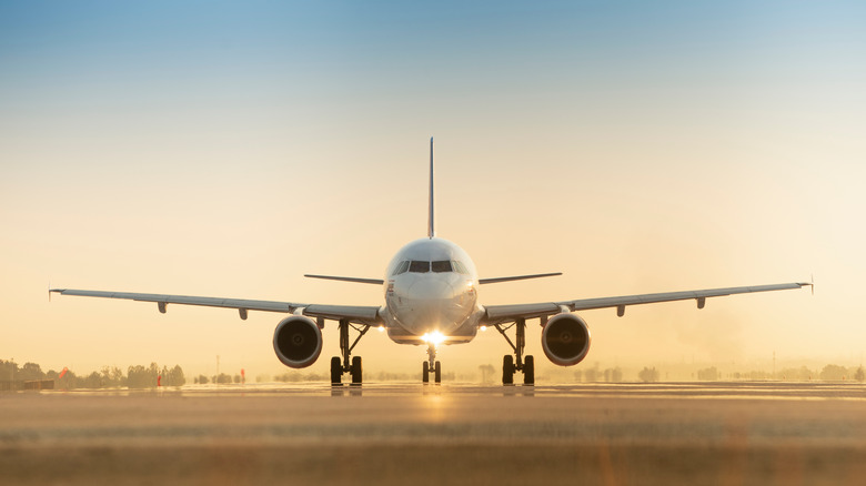 A passenger jet heading down a runway for takeoff