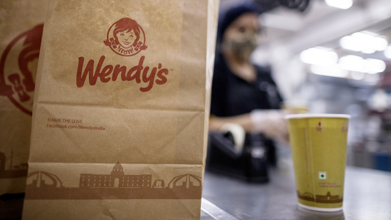 Wendy's bag being next to cup and employee