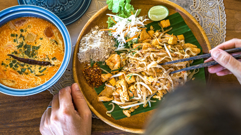 Woman eating a traditional Thai meal