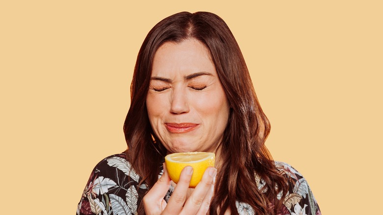 woman puckers from lemon