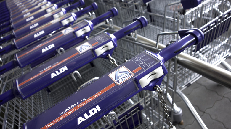 Row of Aldi carts with quarter mechanisms