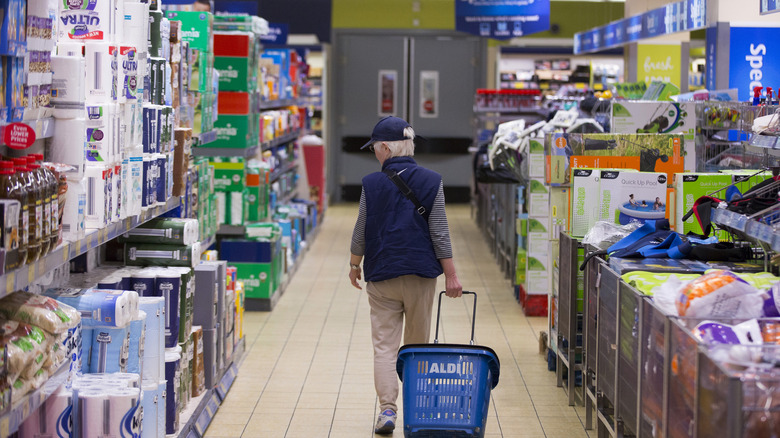 Shopper pulling basket at Aldi