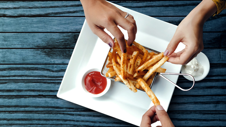 People sharing fries