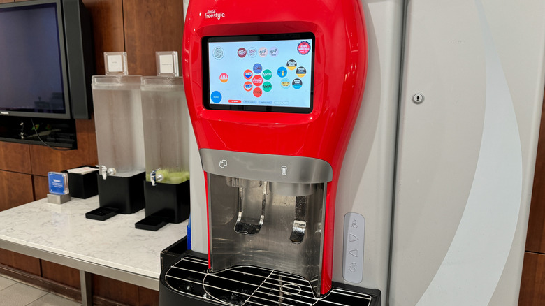 Countertop model of a Coca-Cola Freestyle machine, with a red Coke glass-shaped facade