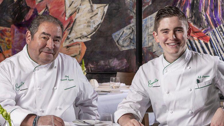 Emeril and E.J. Lagasse smiling while seated