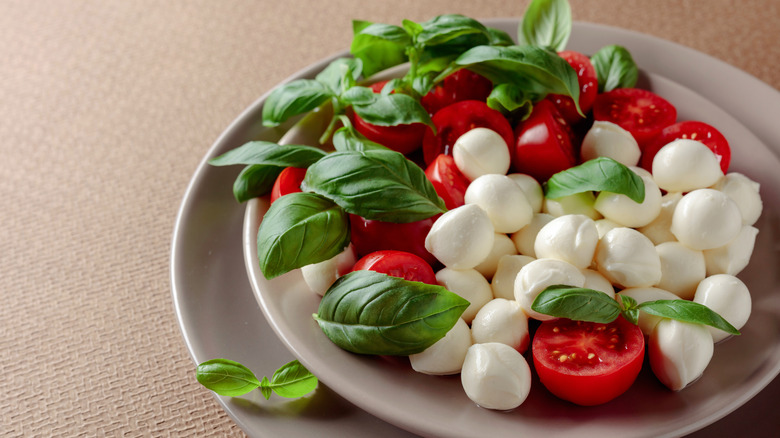 Caprese salad with mozzarella, tomatoes and basil 