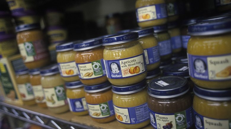 Small jars of baby food on shelves.