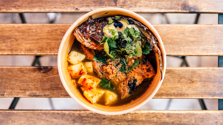 top down of bouillabaisse in a bowl on wooden table