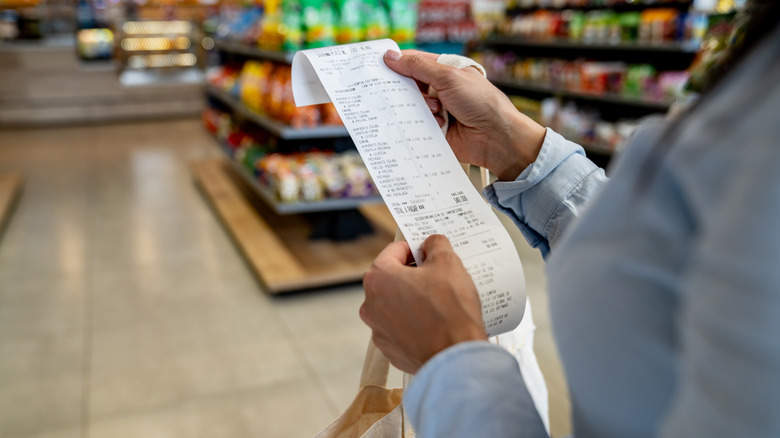person checking their receipt