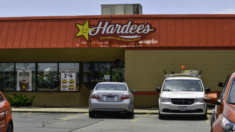 Hardee's store exterior, with several cars in the parking lot