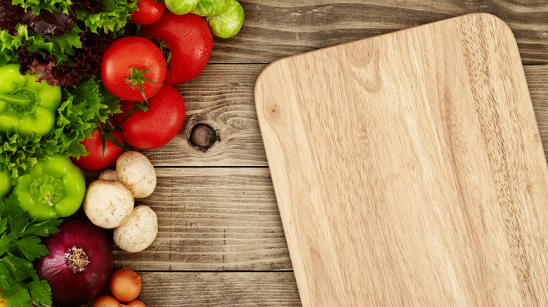 Wooden cutting board with vegetables