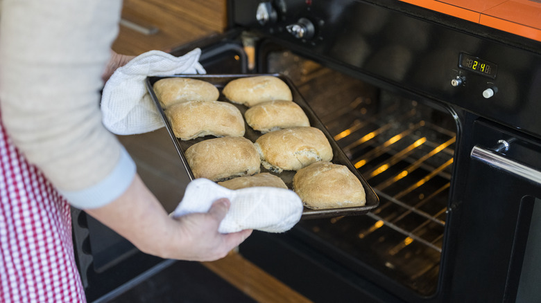 removing baked bread from oven