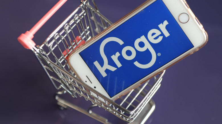 Kroger app on phone in shopping cart