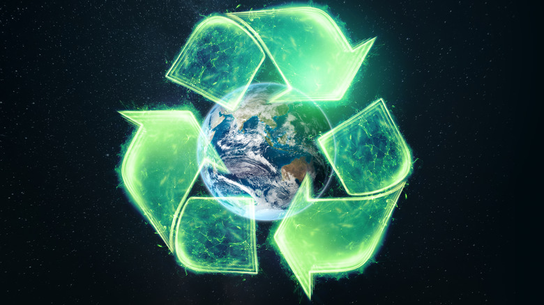 Recycle logo over the globe
