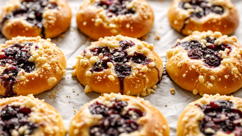 Blueberry kolaches on parchment paper